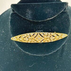 1928 brand gold tone brooch with clear rhinestones